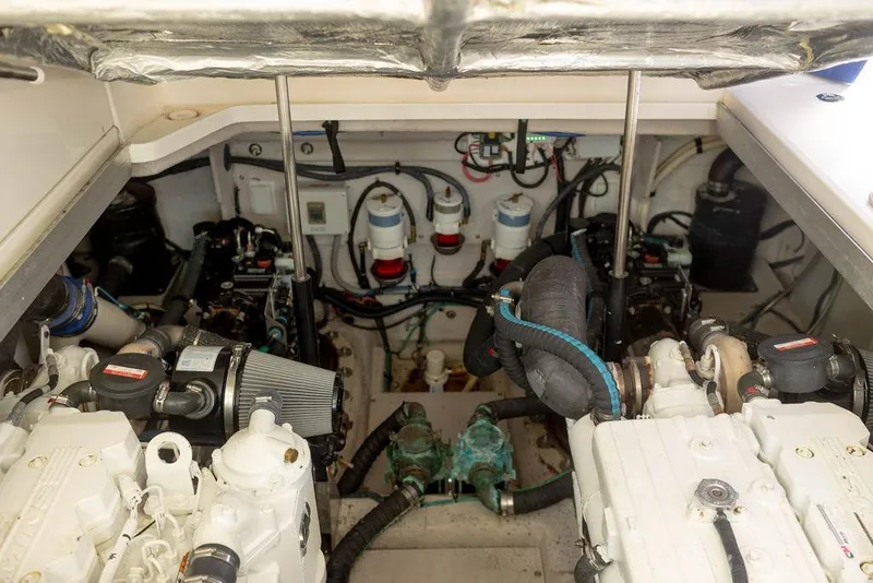 Slide: The Image of Engine room of 2009 Searay 43 Sundancer, showcasing dual engines and mechanical components. - 36