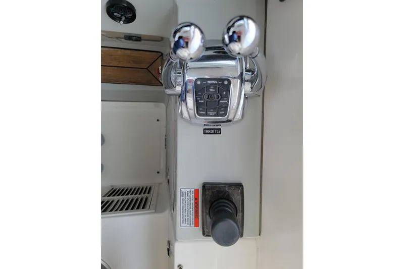 Slide: The Image of Throttle controls of a 2009 Searay 43 Sundancer boat, featuring dual levers and control panel. - 45