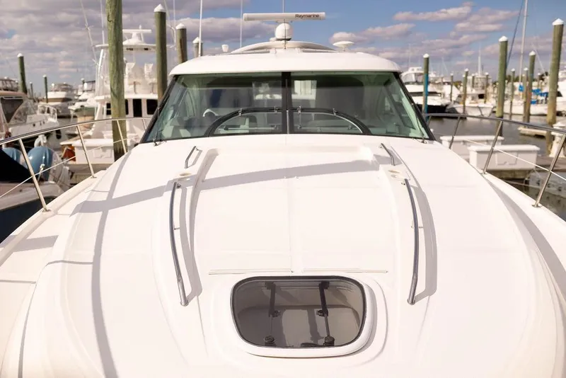 Slide: The Image of 2009 Searay 43 Sundancer yacht docked at marina under blue sky. - 5