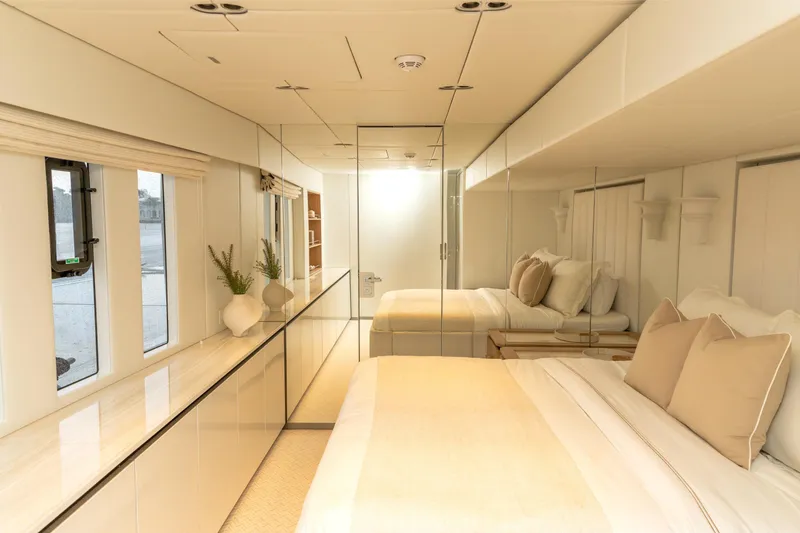 Slide: The Image of Luxurious bedroom interior of 2024 Sunreef 80 Power Cat yacht, featuring elegant design and neutral tones. - 16