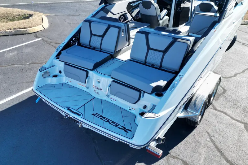 Slide: The Image of 2024 Yamaha Boats 255XE, sleek design, spacious seating, and modern features on a trailer. - 10