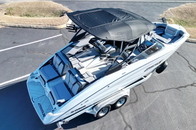 Slide: The Image of 2024 Yamaha Boats 255XE on trailer, featuring sleek design and spacious seating. - 15