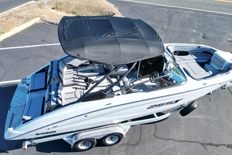 Slide: The Image of 2024 Yamaha Boats 255XE on trailer, featuring sleek design and spacious seating. - 16