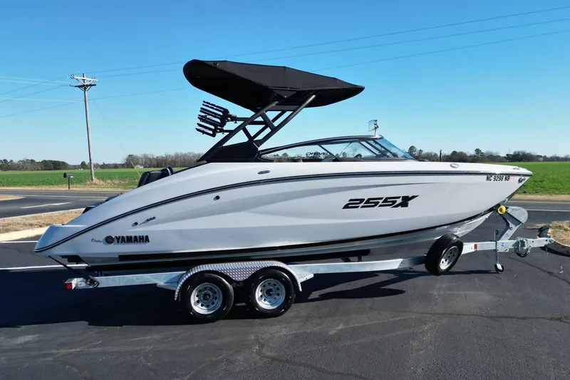 Slide: The Image of 2024 Yamaha Boats 255XE on trailer, sleek design, outdoor setting. - 3