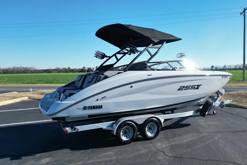 Slide: The Image of 2024 Yamaha Boats 255XE on trailer, sleek design, parked outdoors. - 4