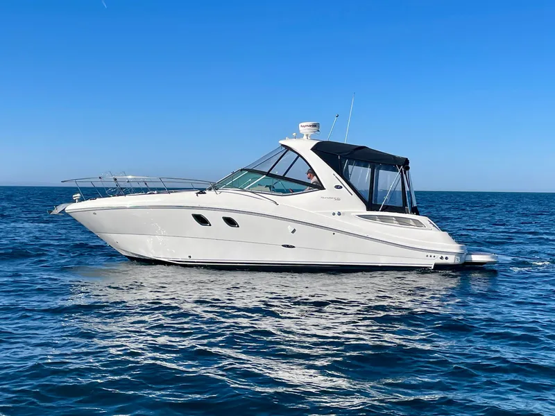The Image of 2014 Sea Ray 330 Sundancer yacht cruising on open blue water. - 0