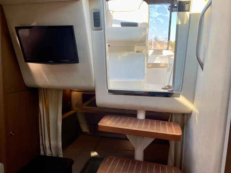 Slide: The Image of Interior of 2014 Sea Ray 330 Sundancer with TV and wooden steps. - 16