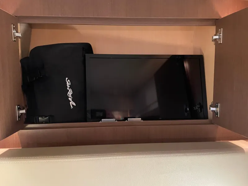 Slide: The Image of Cabinet with TV and Sea Ray bag on 2014 Sea Ray 330 Sundancer yacht. - 19