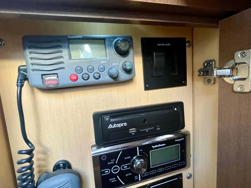 Slide: The Image of Control panel inside 2014 Sea Ray 330 Sundancer boat, featuring radio and electronic equipment. - 22