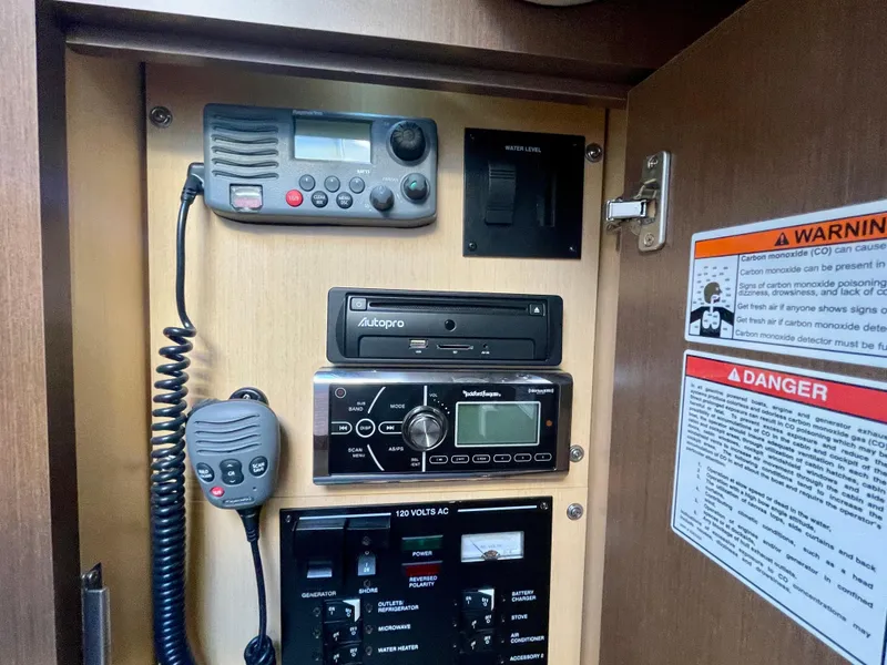 Slide: The Image of Control panel of 2014 Sea Ray 330 Sundancer with radio and warning labels. - 23
