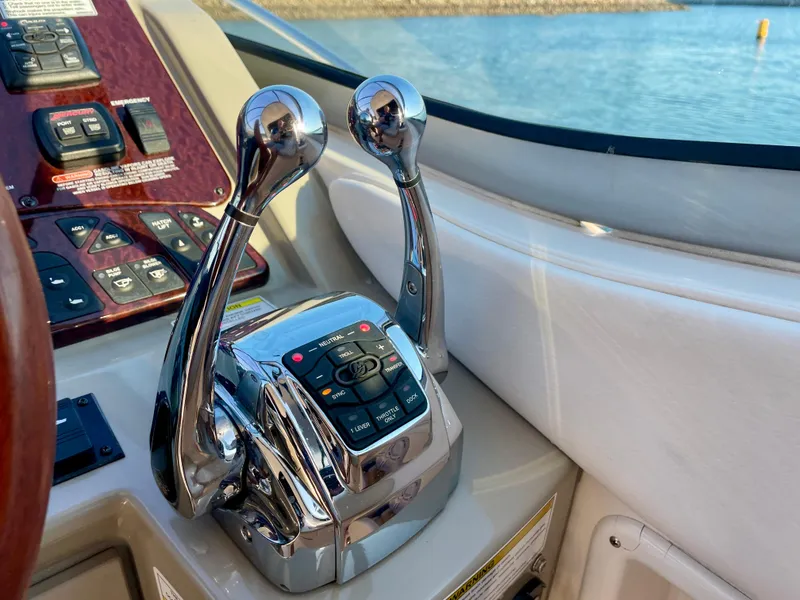 Slide: The Image of Chrome throttle controls on 2014 Sea Ray 330 Sundancer boat dashboard. - 28