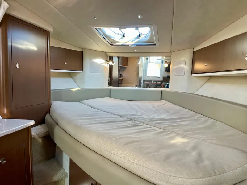 Slide: The Image of Interior cabin of 2014 Sea Ray 330 Sundancer with skylight and cozy bed. - 9