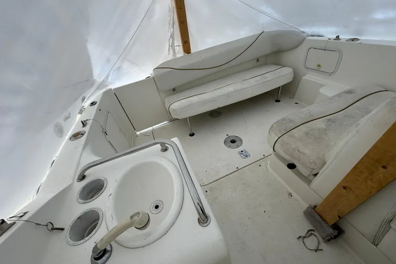 Slide: The Image of 2000 Sea Ray 245 Weekender boat interior with seating and sink. - 11