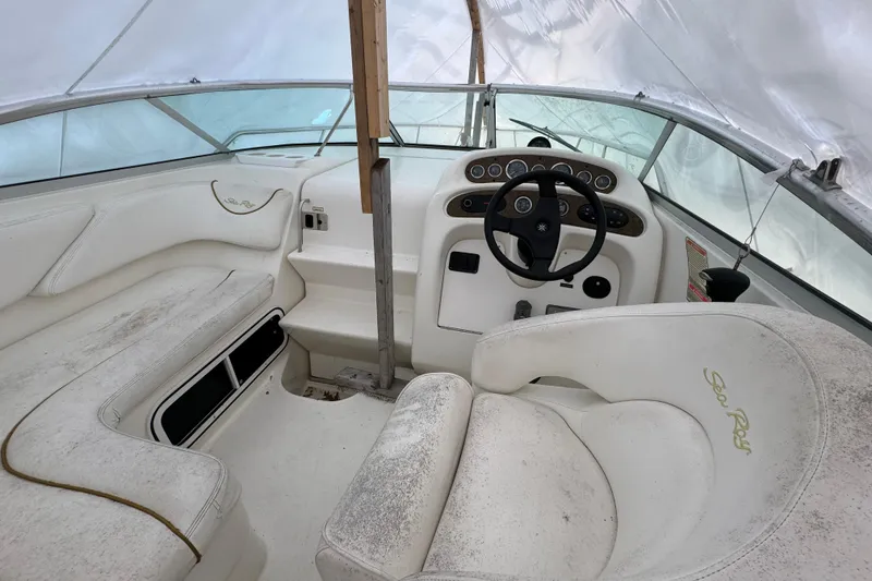 Slide: The Image of 2000 Sea Ray 245 Weekender boat interior with steering wheel and seating. - 12