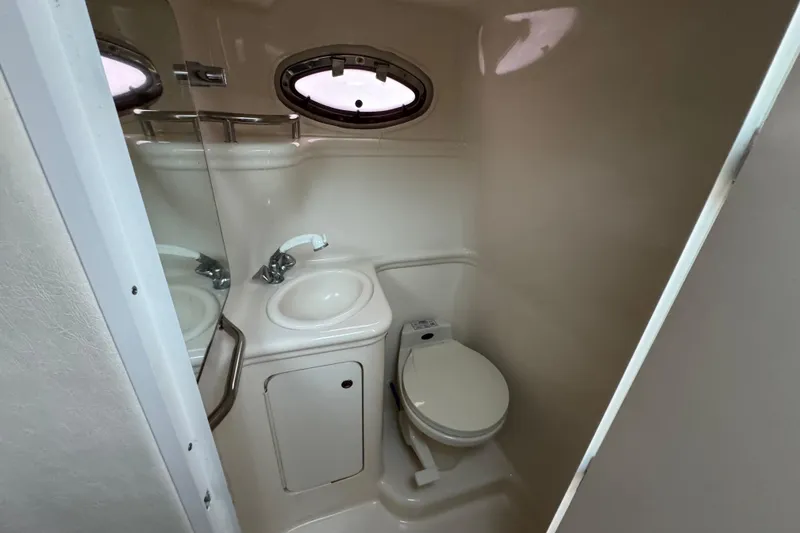 Slide: The Image of Compact bathroom in 2000 Sea Ray 245 Weekender boat with sink and toilet. - 4