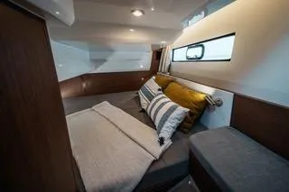 Slide: The Image of 2026 Beneteau Antares 9 cabin interior with cozy bedding and modern design. - 12