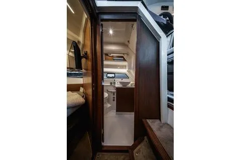 Slide: The Image of 2026 Beneteau Antares 9 interior cabin with modern design and wood accents. - 15