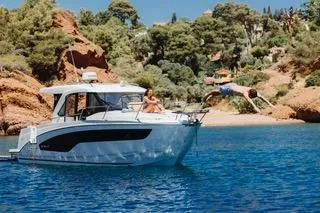 Slide: The Image of 2026 Beneteau Antares 9 boat on calm water, front view. - 2