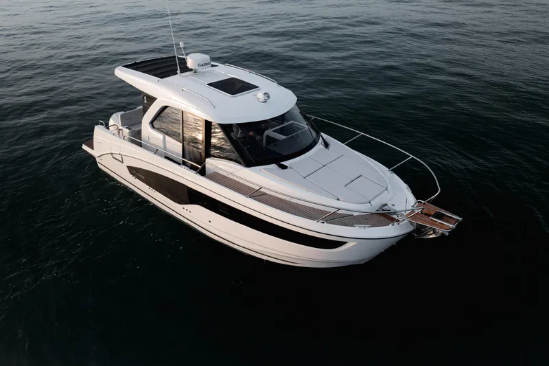 Slide: The Image of 2026 Beneteau Antares 9 boat cruising on calm waters at sunset. - 5
