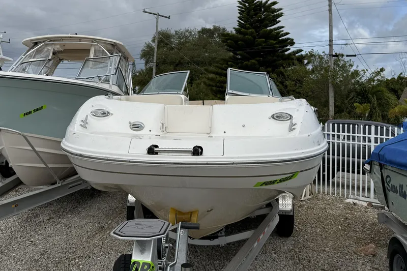 Slide: The Image of 2003 Chaparral Sunesta 263 boat on trailer, for sale, parked outdoors. - 5