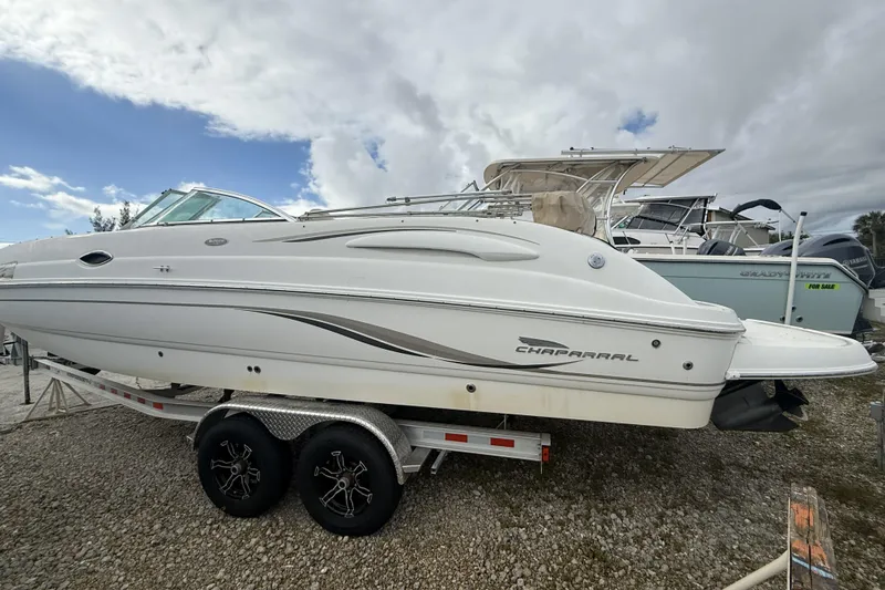 Slide: The Image of 2003 Chaparral Sunesta 263 boat on trailer under cloudy sky. - 6