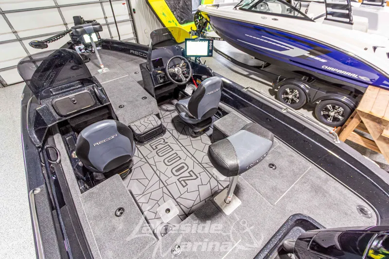 Slide: The Image of 2026 Recon 895 DC fishing boat interior with seating and control panel in showroom. - 11