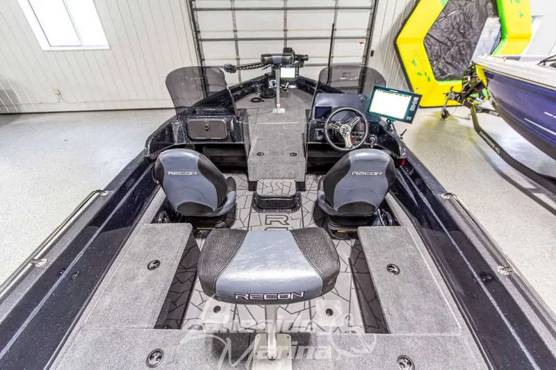 Slide: The Image of 2026 Recon 895 DC boat interior with dual seats, steering console, and modern dashboard. - 13