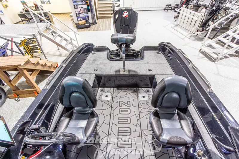 Slide: The Image of Interior of 2026 Recon 895 DC boat with seating and steering wheel in showroom. - 14