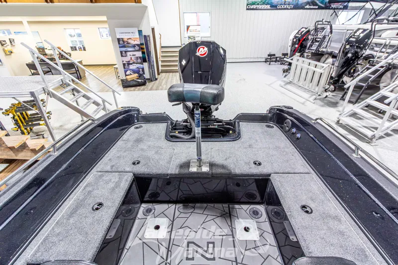 Slide: The Image of 2026 Recon 895 DC boat interior with seating and storage compartments in showroom. - 15