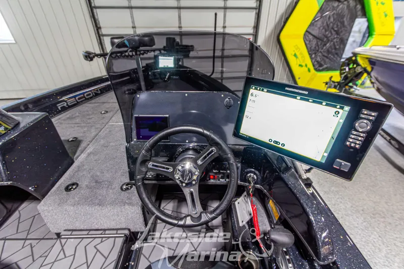Slide: The Image of Cockpit of 2026 Recon 895 DC boat with advanced navigation system and steering wheel. - 20