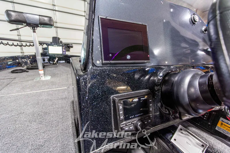 Slide: The Image of 2026 Recon 895 DC boat dashboard with modern controls and electronics in a marina setting. - 21