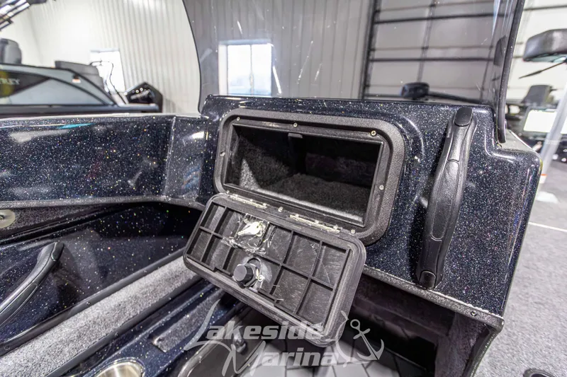 Slide: The Image of 2026 Recon 895 DC boat interior with open storage compartment, sparkly finish, and Lakeside Marina logo. - 24
