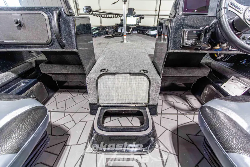 Slide: The Image of Interior of 2026 Recon 895 DC boat, featuring modern dashboard and seating. - 26