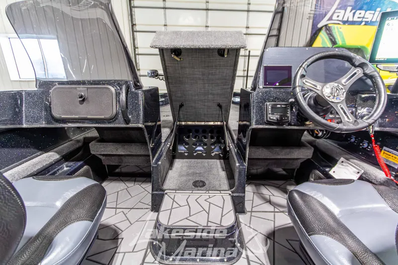 Slide: The Image of Interior view of 2026 Recon 895 DC boat, featuring steering wheel and seating. - 27