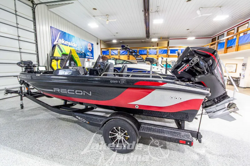Slide: The Image of 2026 Recon 895 DC boat in showroom, featuring sleek design and powerful engine. - 3