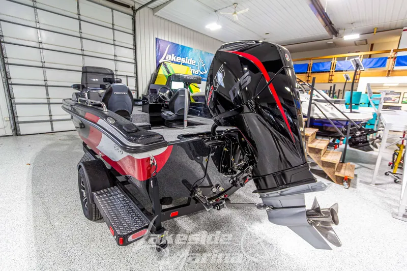 Slide: The Image of 2026 Recon 895 DC boat with powerful outboard motor in showroom setting. - 4