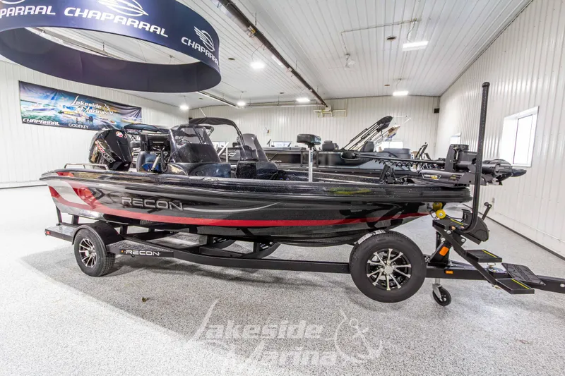 Slide: The Image of 2026 Recon 895 DC boat displayed indoors on a trailer. - 7