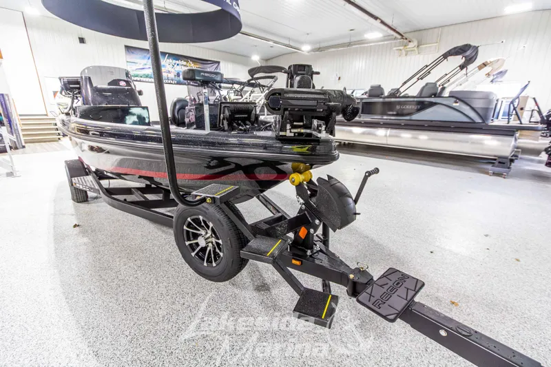 Slide: The Image of 2026 Recon 895 DC boat on trailer in showroom, featuring sleek design and modern equipment. - 8