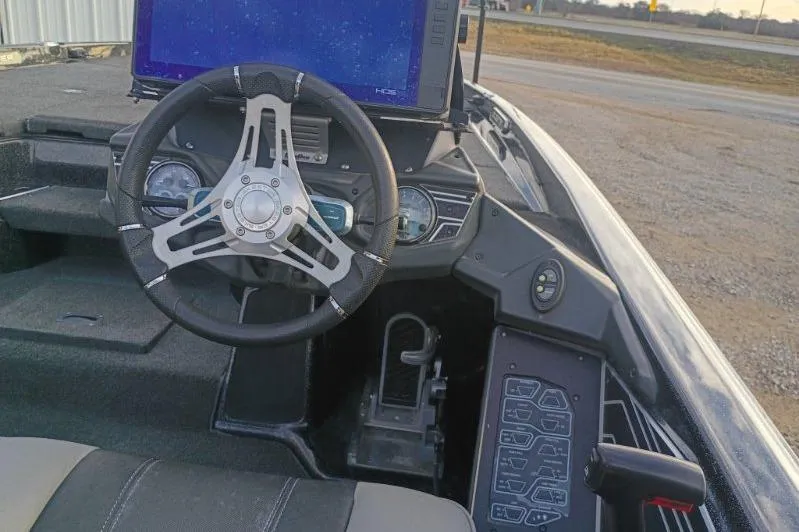 Slide: The Image of 2020 Skeeter FXR21 boat cockpit with steering wheel and control panel. - 3