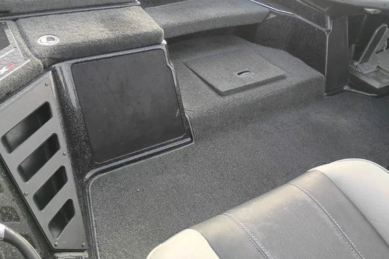Slide: The Image of Interior of a 2020 Skeeter FXR21 boat, featuring seating and storage compartments. - 4