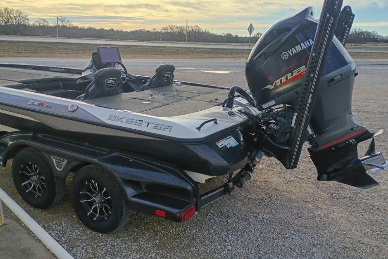 Slide: The Image of 2020 Skeeter FXR21 boat with Yamaha motor on a trailer at sunset. - 5