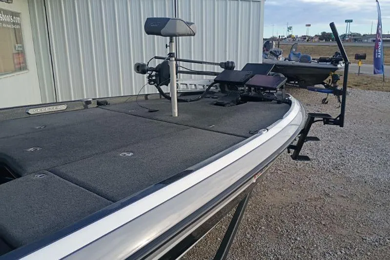 Slide: The Image of 2020 Skeeter FXR21 bass boat with advanced fishing equipment, parked outdoors. - 8