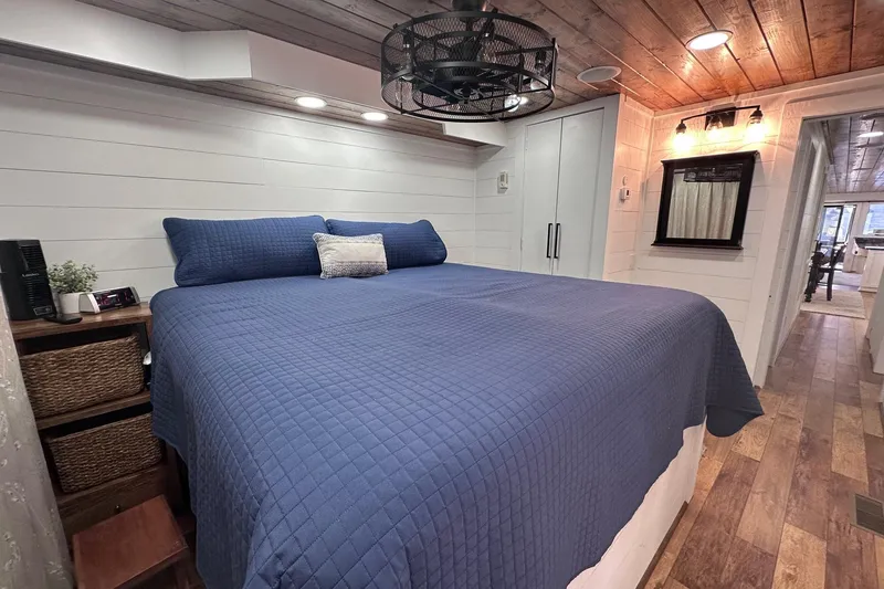 Slide: The Image of Cozy bedroom in 1996 Sumerset 16x83 houseboat with blue bedding and rustic decor. - 12
