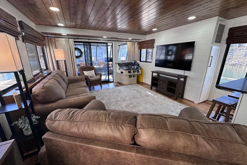 Slide: The Image of Luxurious 1996 Sumerset 16x83 houseboat interior with cozy seating and large TV. - 3