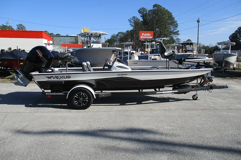The Image of 2026 Vexus AVX 1980 boat on trailer, parked outdoors near storage facility. - 1