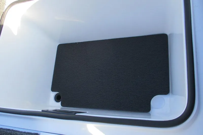 Slide: The Image of 2026 Vexus AVX 1980 storage compartment with black mat and drainage hole. - 27