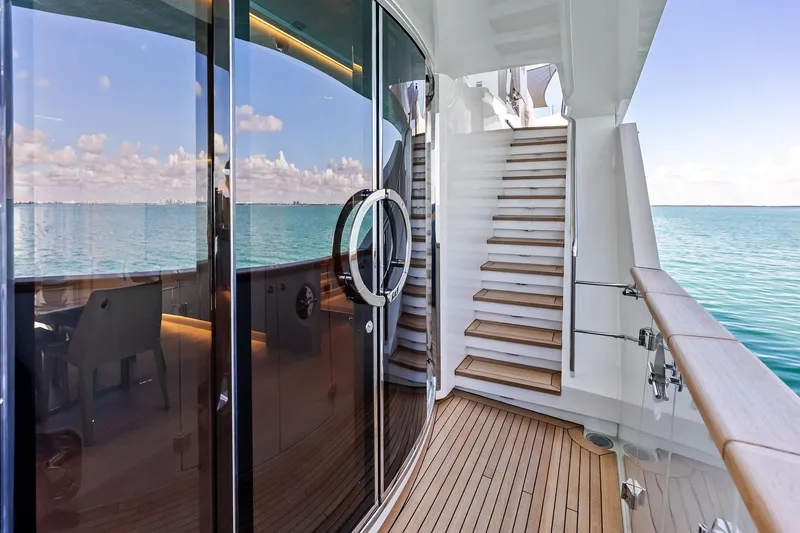 Slide: The Image of Luxurious 2023 Sanlorenzo SD126 yacht deck with ocean view and elegant staircase. - 12