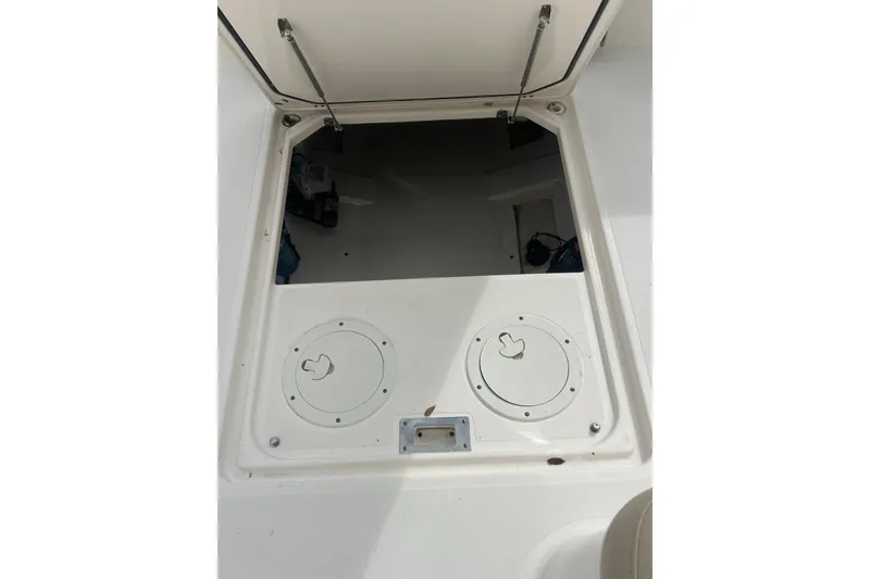 Slide: The Image of Open storage compartment on a 2016 Pursuit DC 325 Dual Console boat. - 10