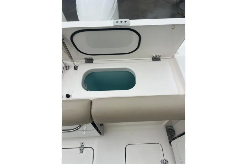 Slide: The Image of Open storage compartment on 2016 Pursuit DC 325 Dual Console boat. - 4