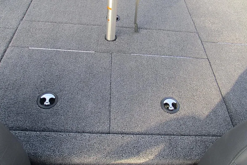 Slide: The Image of 2026 Vexus Defender 189 boat deck with gray carpet and metal fixtures. - 13